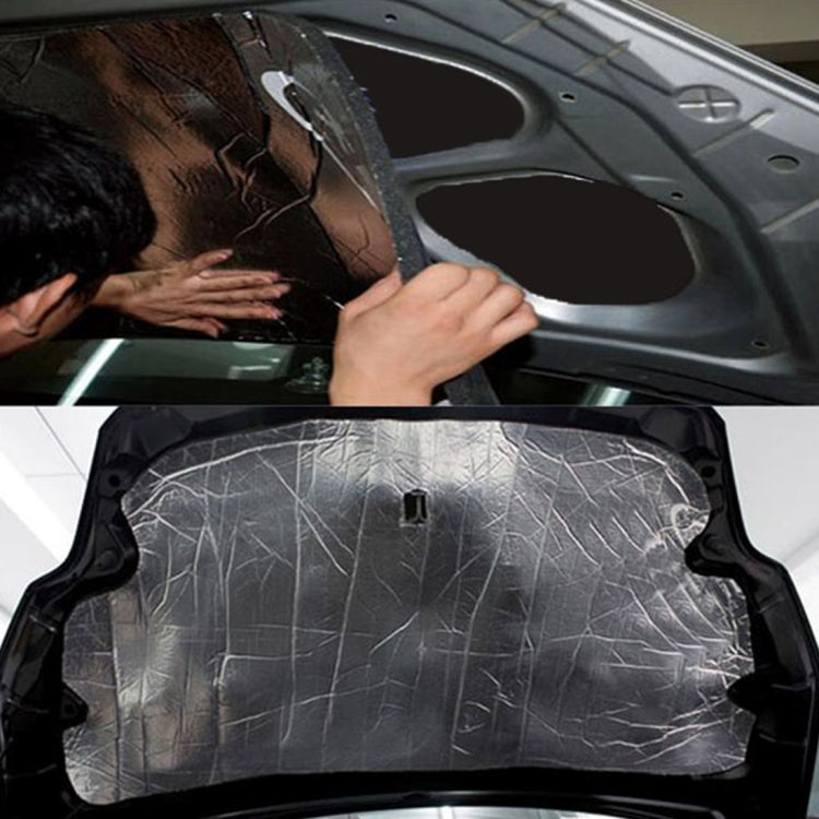 Car hood engine insulation mat being applied under hood by hands