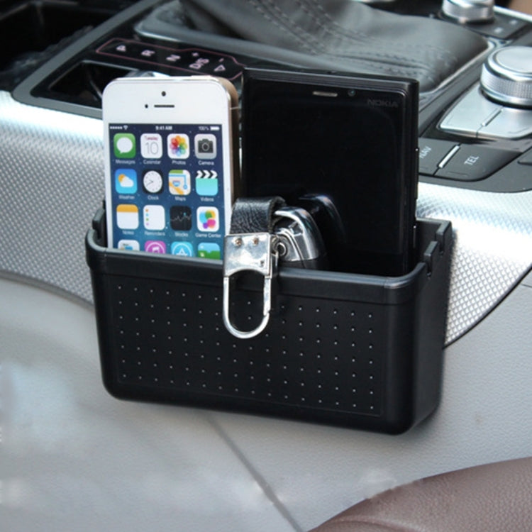Black car storage organizer box with perforated front, phone inside, keyring hook attached.