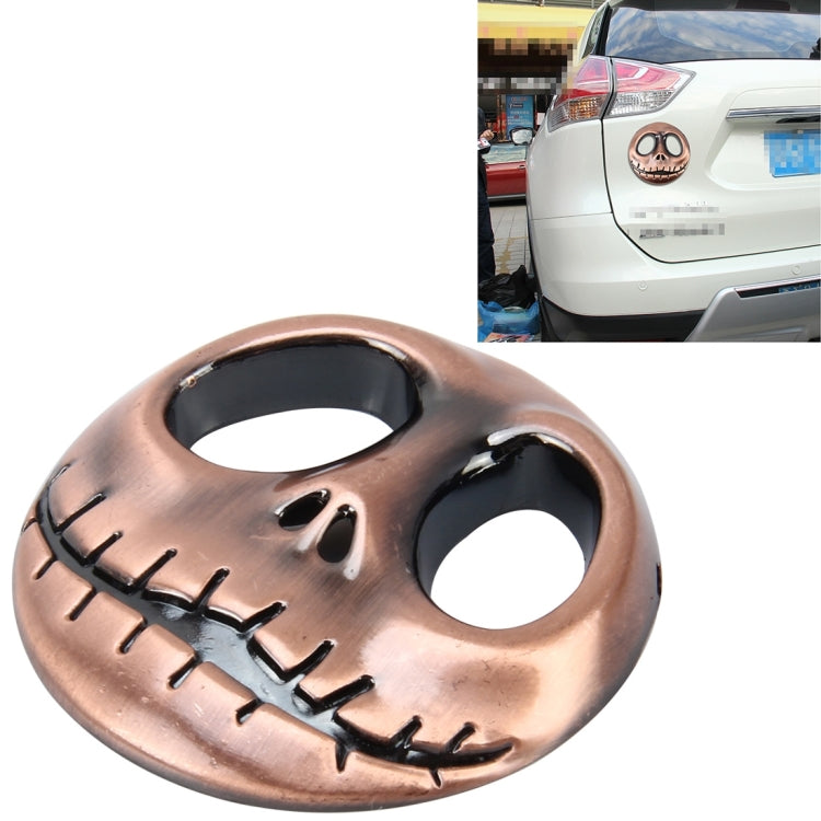 3D metal skull auto sticker with open eye holes and engraved teeth, bronze-gold finish