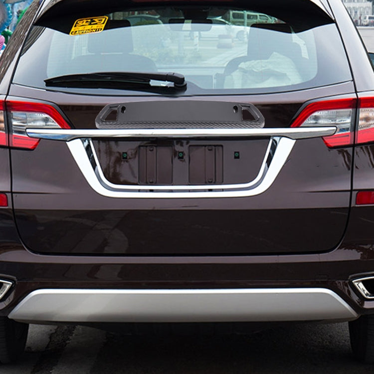 License plate holder installed on car rear, dark carbon-fiber frame with open cutout