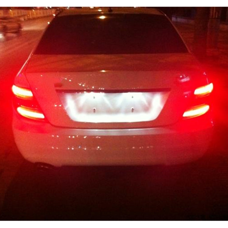 LED brake light bulbs glowing red at the rear, centered on the car trunk