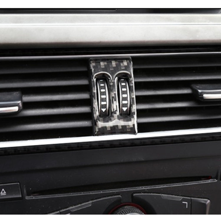 Close-up of carbon fiber air conditioning switch trim sticker on dashboard
