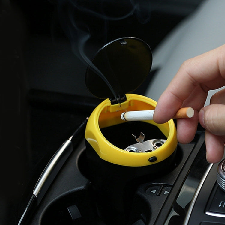 Portable car ashtray trash bin, yellow with lid open and cigarette inside