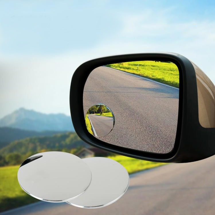 Wide-angle blind spot mirror on car side with chrome rim, plus two spare round mirrors