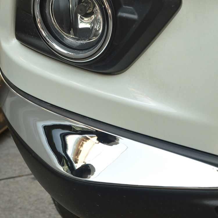 Close-up of silver bumper guard strip installed along front bumper edge