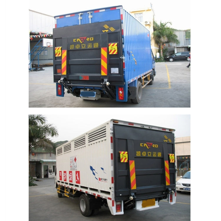 Truck rear and side view showing red/yellow warning chevron stickers on doors
