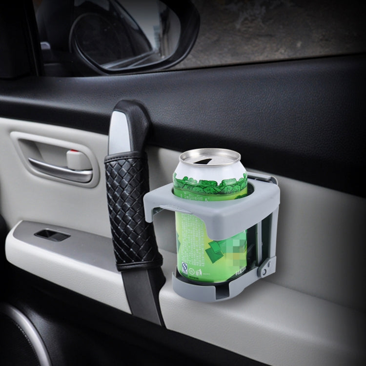 Gray car drink can holder on dashboard, angled view holding a metal can.
