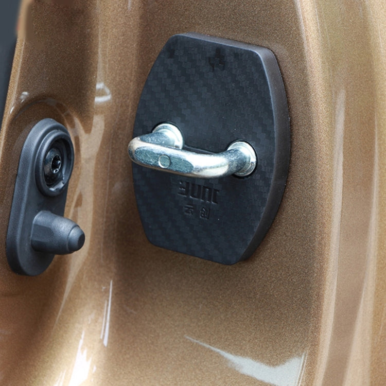 Black carbon-fiber door lock cover fitted on car door lock