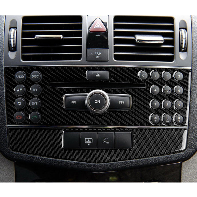 Black carbon fiber center console panel sticker covering radio and control area
