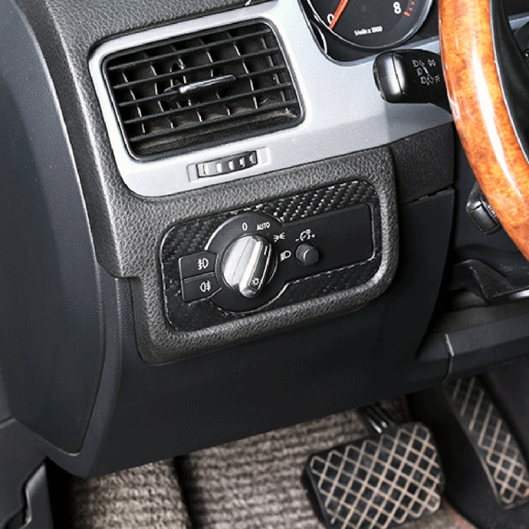 Carbon fiber headlight panel decal applied on car dashboard near control knobs