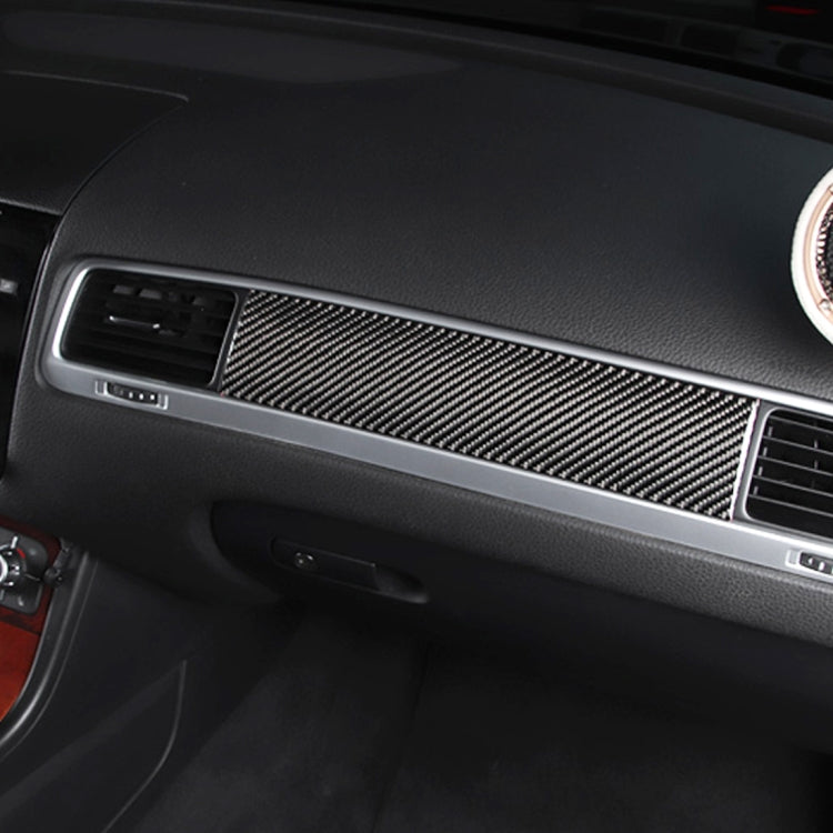 Black carbon fiber dashboard panel sticker installed along the trim panel