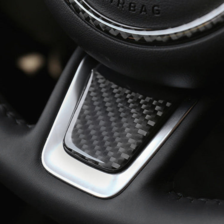 Carbon fiber steering wheel trim sticker in place on black interior panel