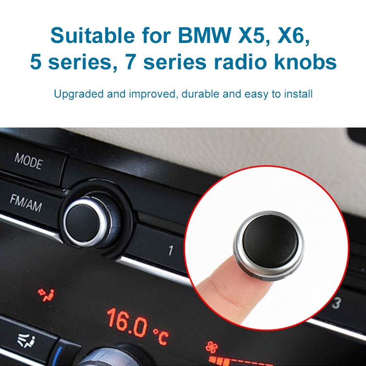 Black car radio knob with silver ring installed on dashboard control panel