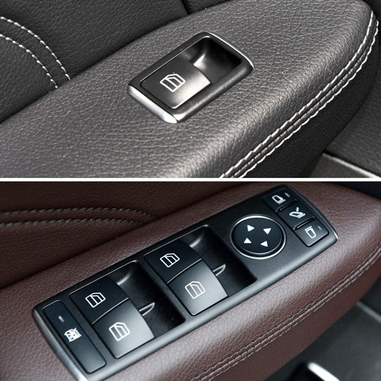 Power window switch set with window icon buttons, black panel on leather trim