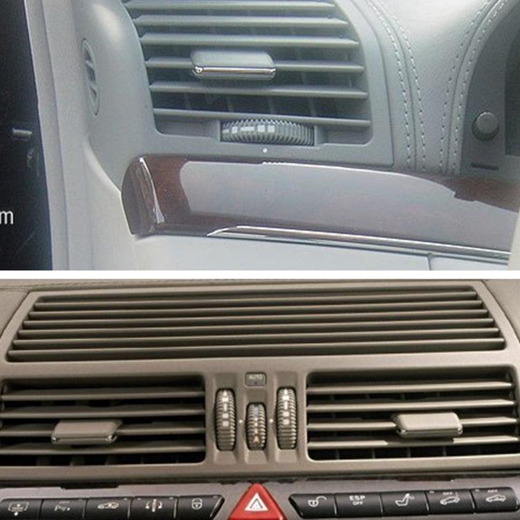 Installed car HVAC air vent switch paddles in dashboard, two dark gray levers on sides