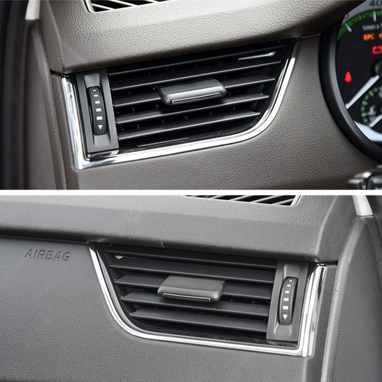 Installed black air vent control paddle in dashboard grille