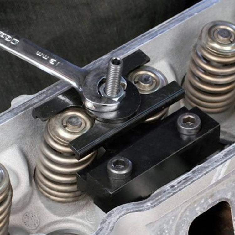 Valve spring compressor tool installed on LS engine with threaded rod and clamp