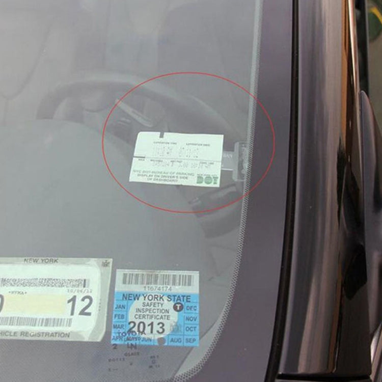 Car ticket holder mounted on windshield with parking pass in white pocket