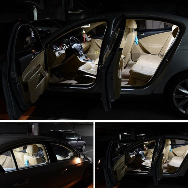 Car interior with overhead dome reading light glowing near the open door