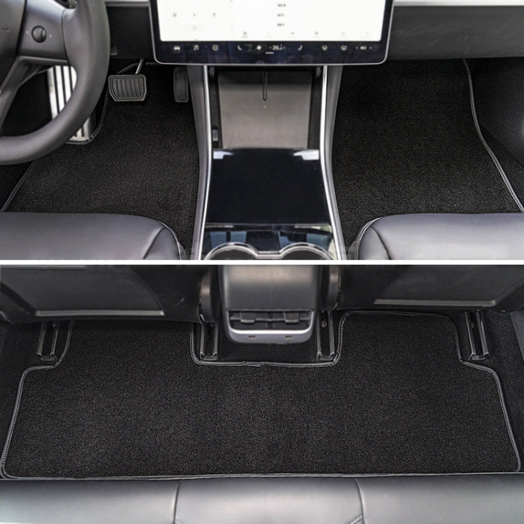 Black velvet car floor mat set installed, covering driver and passenger footwells.