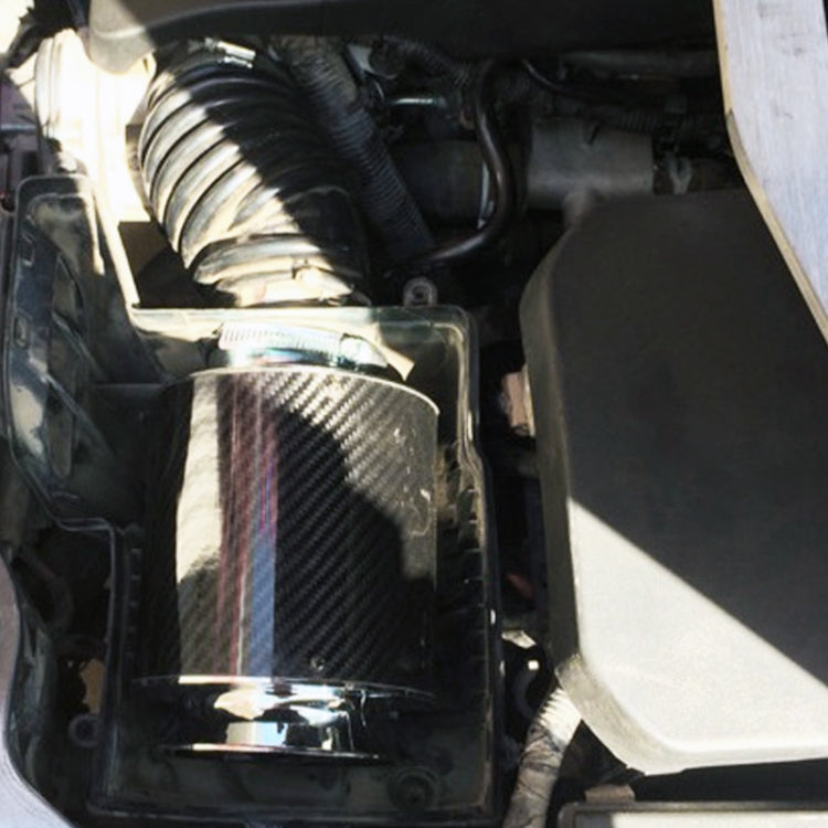 Engine bay view of carbon fiber mushroom air filter with chrome tubing connection