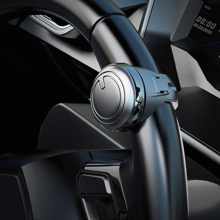 Silver circular steering wheel spinner knob attachment on steering wheel, close-up view