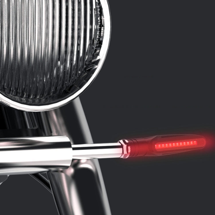 Close-up of red glowing motorcycle LED turn signal light bar on chrome mounting