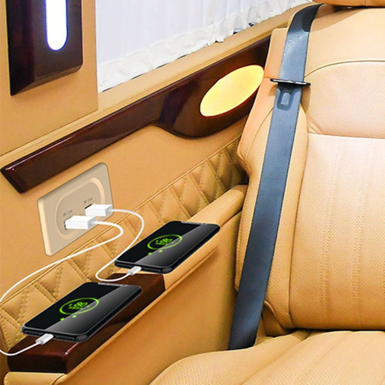 Dual USB car charger installed on vehicle console beside seat