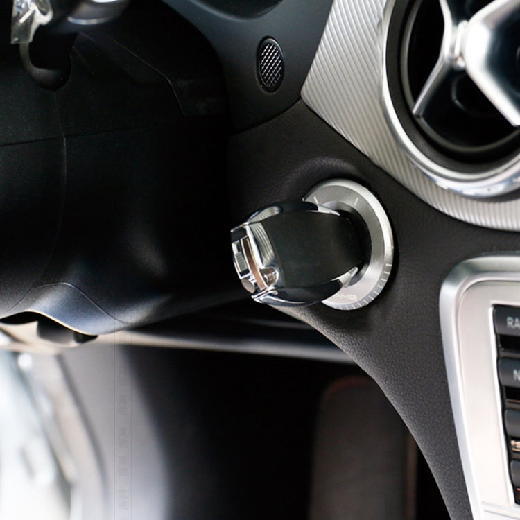 Chrome ignition key ring in car console near start switch