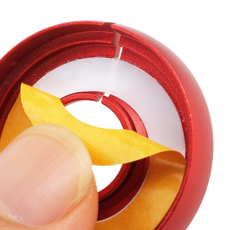 Volkswagen metal ignition key ring close-up, red/orange dial adjusted by hand