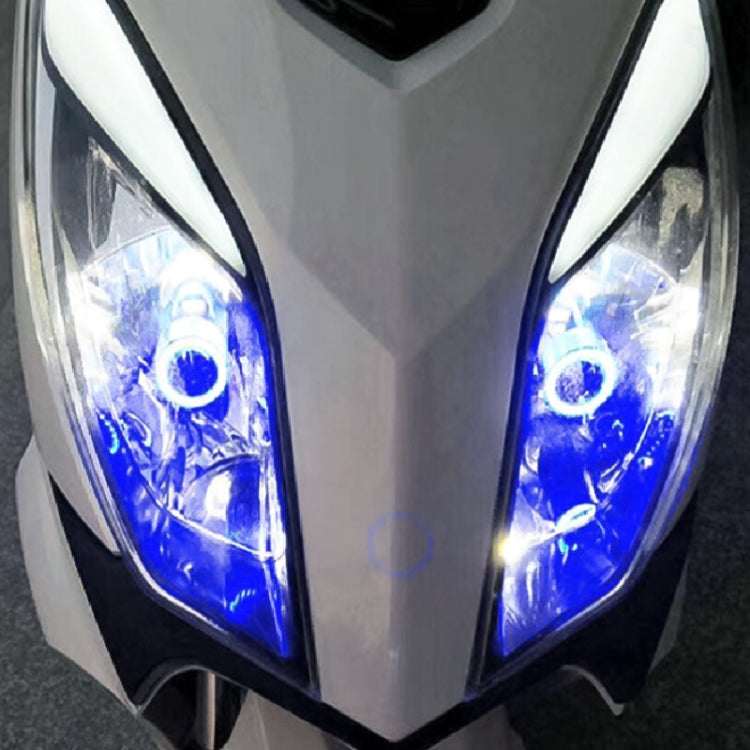 Front motorcycle headlight with two blue angel eyes and illuminated projector beams