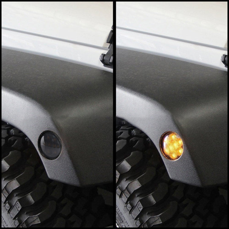 Installed LED wheel eyebrow turn signal on car fender, amber light illuminated