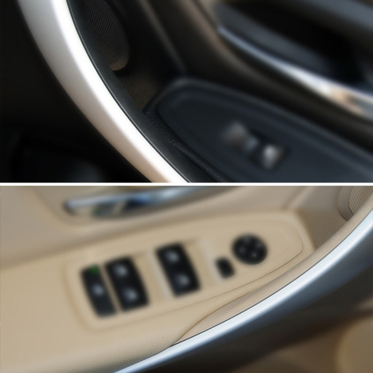 Beige inner door armrest handle close-up with control buttons and switch panel