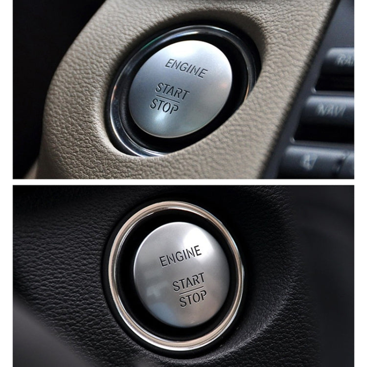 Silver engine start/stop push button with chrome ring on black trim