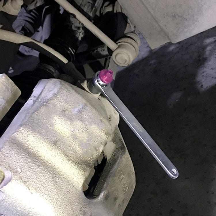11mm brake bleeder wrench tool used near brake caliper, long handle with purple valve