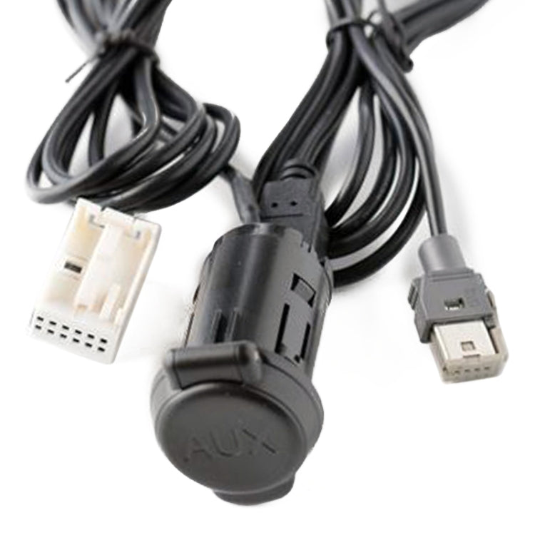 Car audio adapter cable close-up: AUX plug cap and USB connectors on black cord