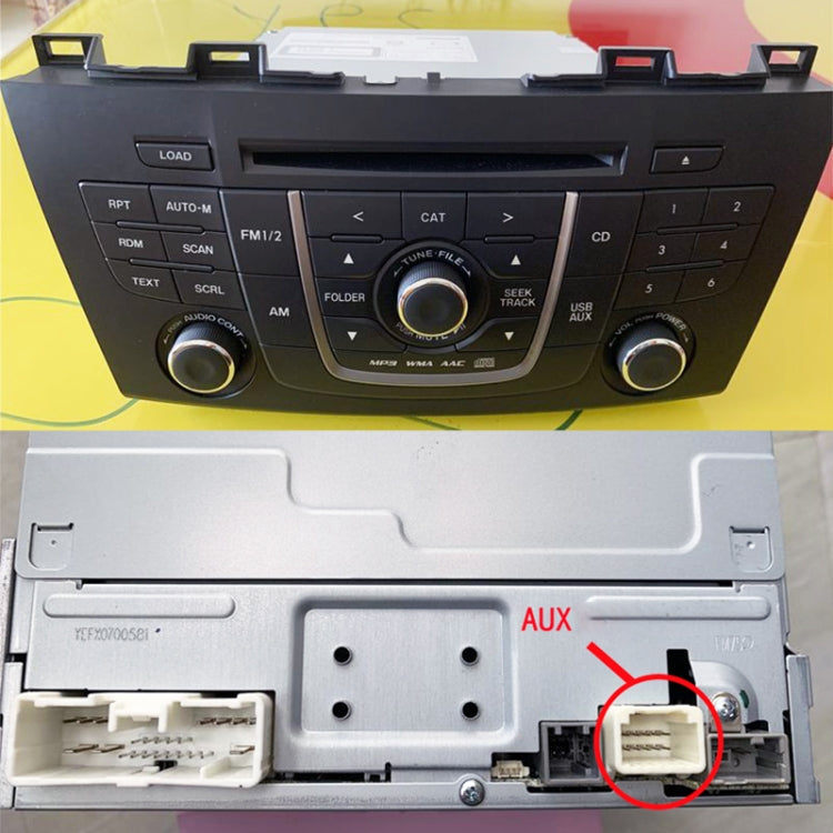 Car stereo AUX port connector area with mounting bracket and cable plug