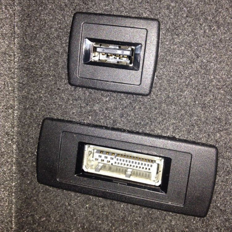 In-dash input ports for a car AUX audio cable, showing two connector slots