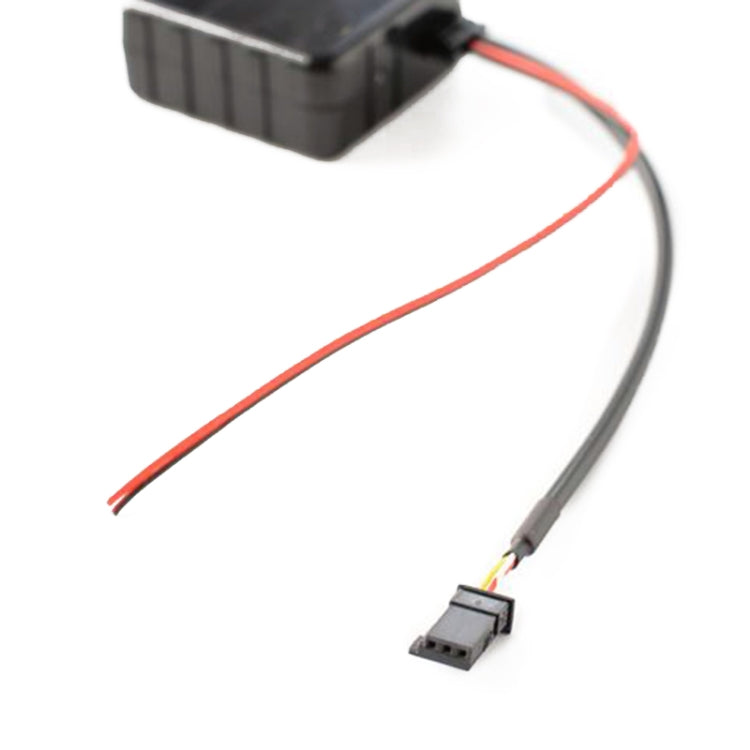 Close-up of black wiring harness module with red and gray cable connectors