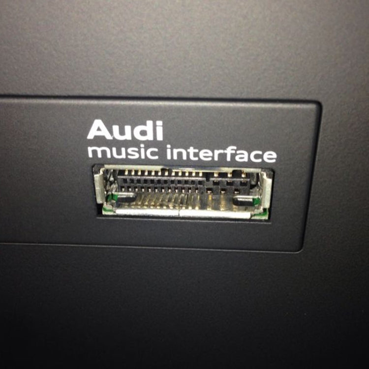 Audi music interface port with multi-pin connector, inset in dashboard panel