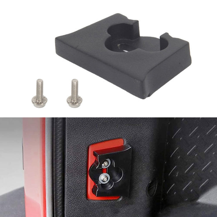 Black rubber limit block installed near tailgate latch with two screws