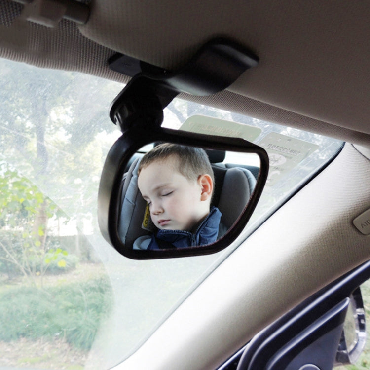 Black child seat observation mirror with suction mount, shown in the car