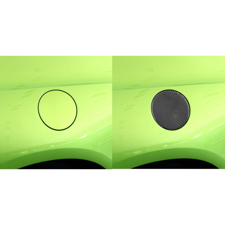 Two round carbon fiber-look fuel tank cover stickers on vehicle body