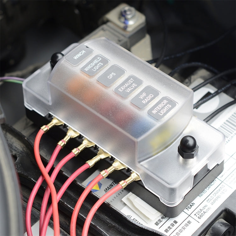 Covered auto fuse box module with labeled top and multi-terminal wiring