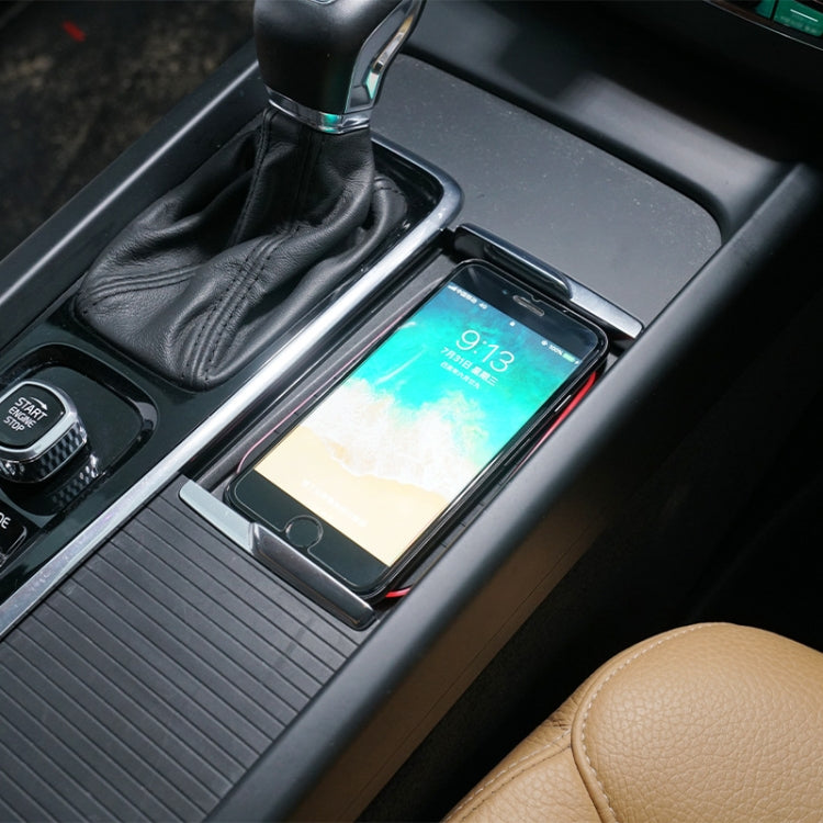 Wireless charger installed in car center console holding a phone on the charging pad