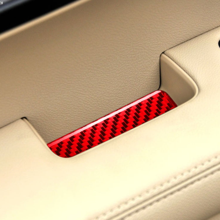 Red carbon-fiber style inner armrest gasket sticker installed on car armrest