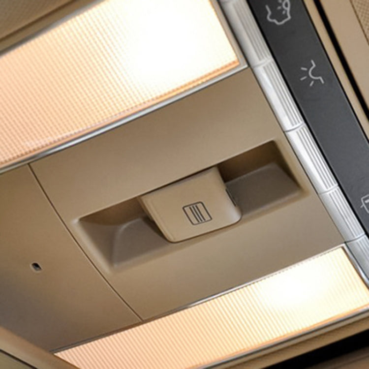 Beige sunroof switch button mounted in overhead console with vent icon