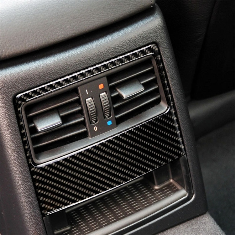 Carbon fiber rear air vent trim sticker installed, showing twin vents in carbon weave