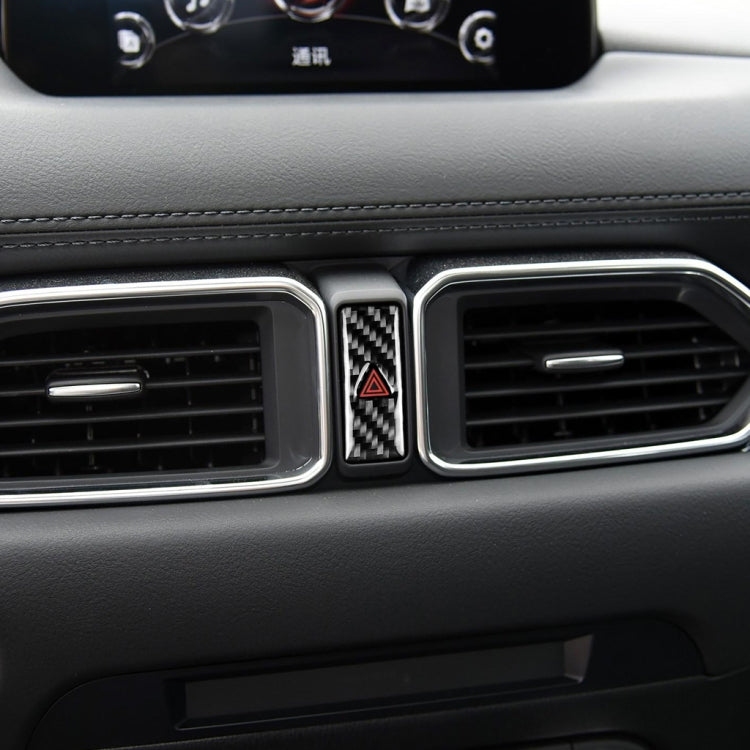 Installed warning light decal on car dashboard air vent, carbon fiber texture