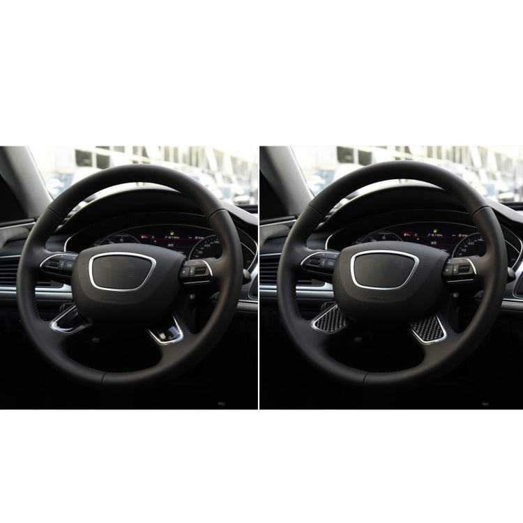 Steering wheel with applied black carbon-fiber button trim accents on controls